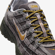 Vue zoomée sur les détails latéraux de la Nike P-6000 Premium Cordura Medium Ash Golden Hops en tons gris et brun, avec empeigne en cuir, daim et CORDURA® et semelle en mousse.