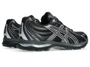 ASICS Gel-Sekiran Black Carbon en mesh noir avec détails gris anthracite, amorti GEL et silhouette technique contemporaine.