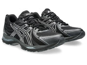 ASICS Gel-Sekiran Black Carbon en mesh noir avec détails gris anthracite, amorti GEL et silhouette technique contemporaine.