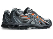 ASICS Gel-Sekiran Piedmont Grey Orange en mesh gris avec détails orange vif, amorti GEL et silhouette technique contemporaine.