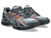 ASICS Gel-Sekiran Piedmont Grey Orange en mesh gris avec détails orange vif, amorti GEL et silhouette technique contemporaine.