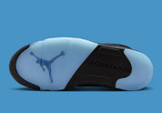 Air Jordan 5 Retro Black University Blue 2026 en nubuck noir avec accents bleus, languette réfléchissante et unité Air visible au talon.