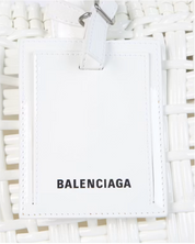 Balenciaga Bistro S Basket Top Handle Bag Optic White en matière tressée blanche avec deux anses roulées et bandoulière amovible.