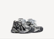 Balenciaga Runner Grey White Black avec tige en mesh respirant, empiècements en cuir gris, blanc et noir, semelle intermédiaire en mousse et silhouette inspirée du running rétro.