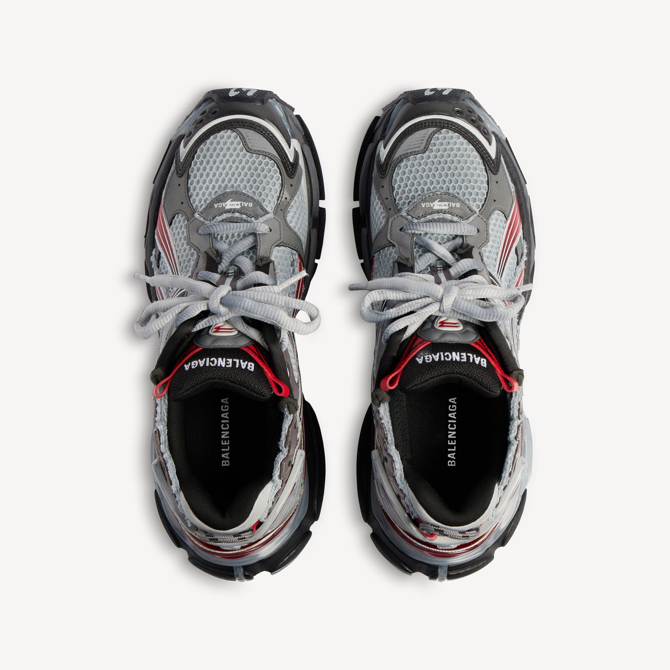 Balenciaga Runner White Black Gradient avec tige en mesh respirant, empiècements en cuir blanc et noir dégradé, semelle intermédiaire en mousse et silhouette running vintage.