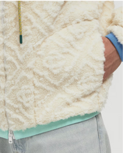 Casablanca Monogram Fleece Jacket Off White, veste polaire Casablanca blanc cassé à manches longues avec motif Monogram et fermeture zippée.