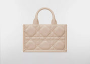 Dior Mini Dior Book Macrocannage Calfskin Tote Powder Beige, mini sac cabas en cuir de veau beige poudré avec surpiqûres Cannage et charms D.I.O.R. dorés vue de dos. 