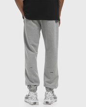 Nike x NOCTA Fleece CS Sweatpant Dark Grey Heather, pantalon fleece gris chiné avec poignets côtelés, poches zippées et détails NOCTA.