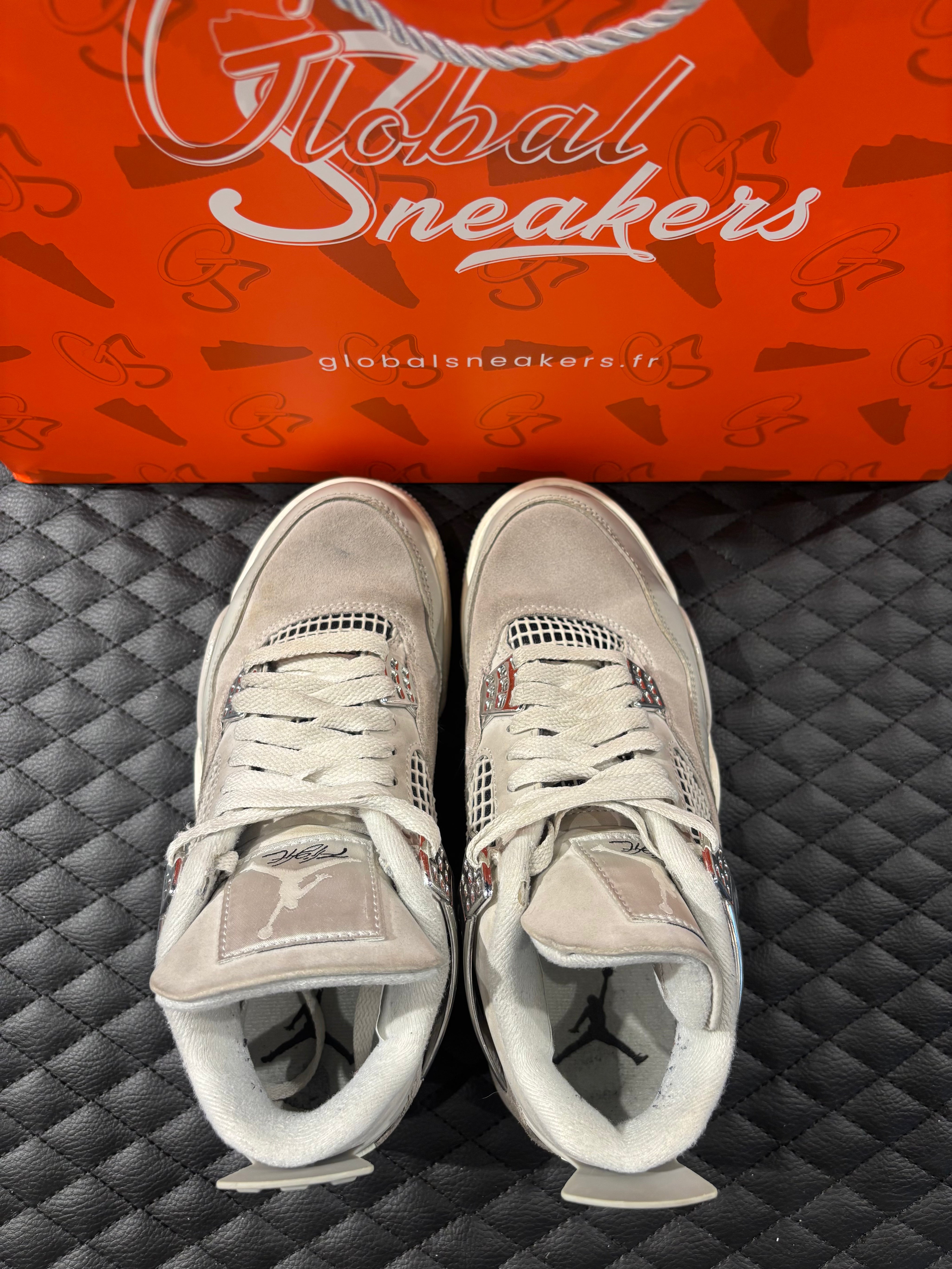 Jordan 4 Rétro Frozen Moments femme d’occasion en état 8,5/10, cuir gris perlé, détails texturés, sneaker sans boîte.