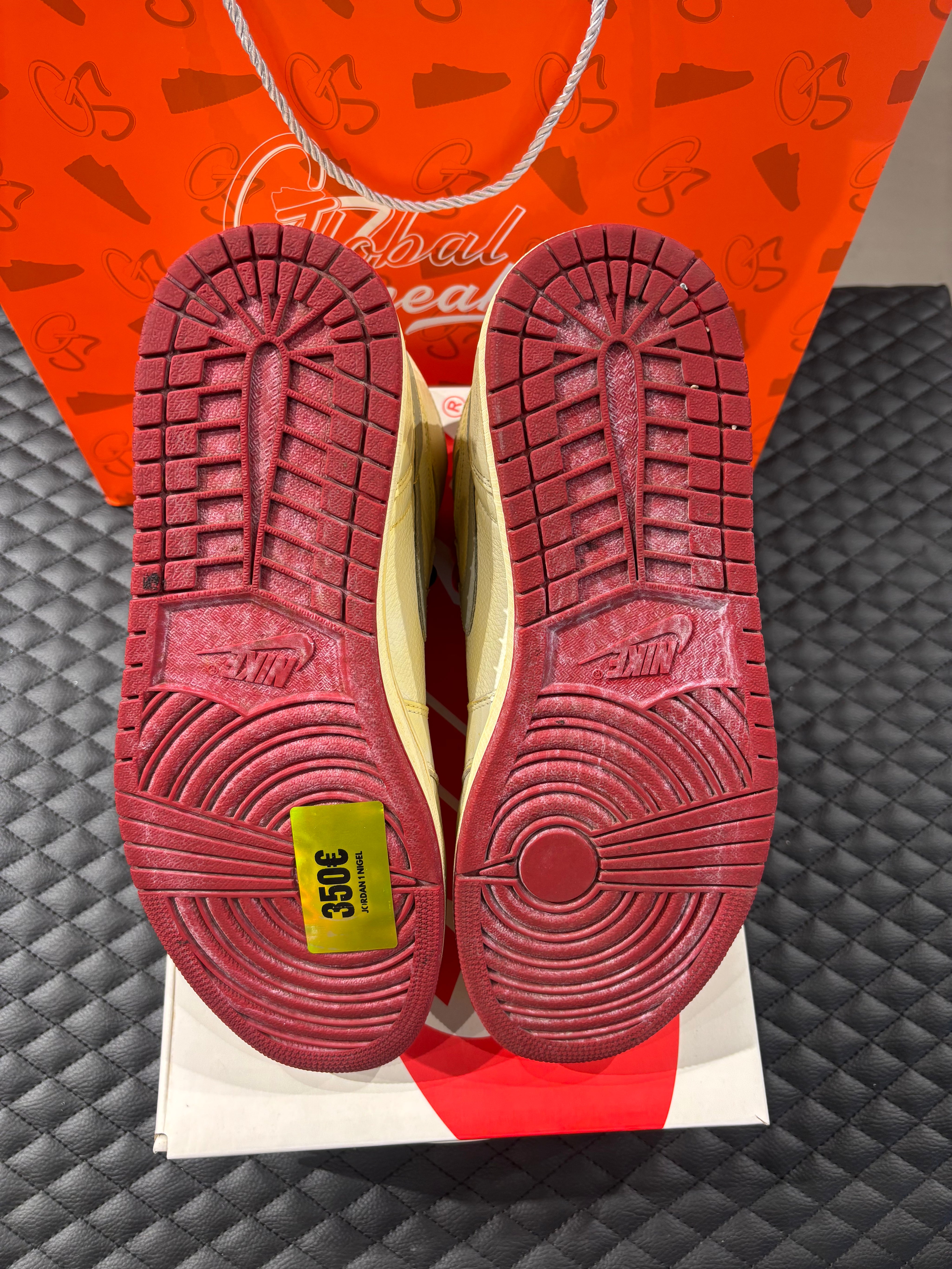 Jordan 1 High Rétro Nigel Sylvester d’occasion en état 8,5/10, cuir blanc patiné, détails crème et noirs, sneaker avec boîte.