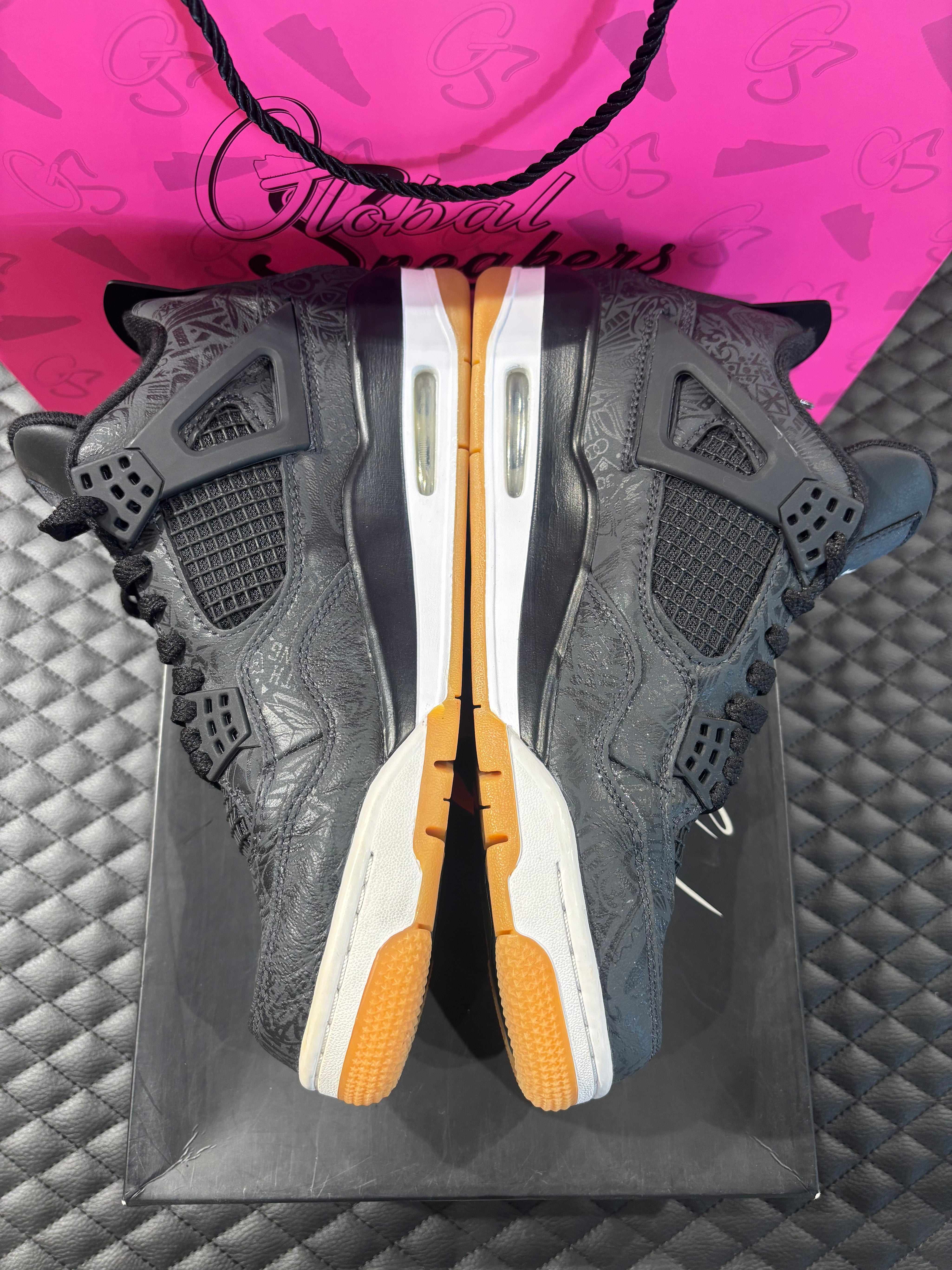 Jordan 4 Rétro Laser noir et gomme d’occasion en état 9/10, cuir noir gravé au laser, semelle gomme, sneaker avec boîte.