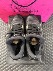 Jordan 4 Rétro Oreo d’occasion en état 8,5/10, cuir noir, détails gris mouchetés, silhouette emblématique, sneaker avec boîte.

