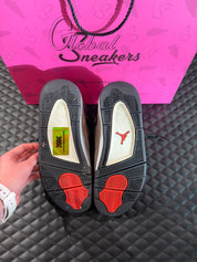 Sneakers Jordan 4 Taupe Haze d’occasion en cuir premium avec amorti Air-Sole visible et semelle caoutchouc durable.