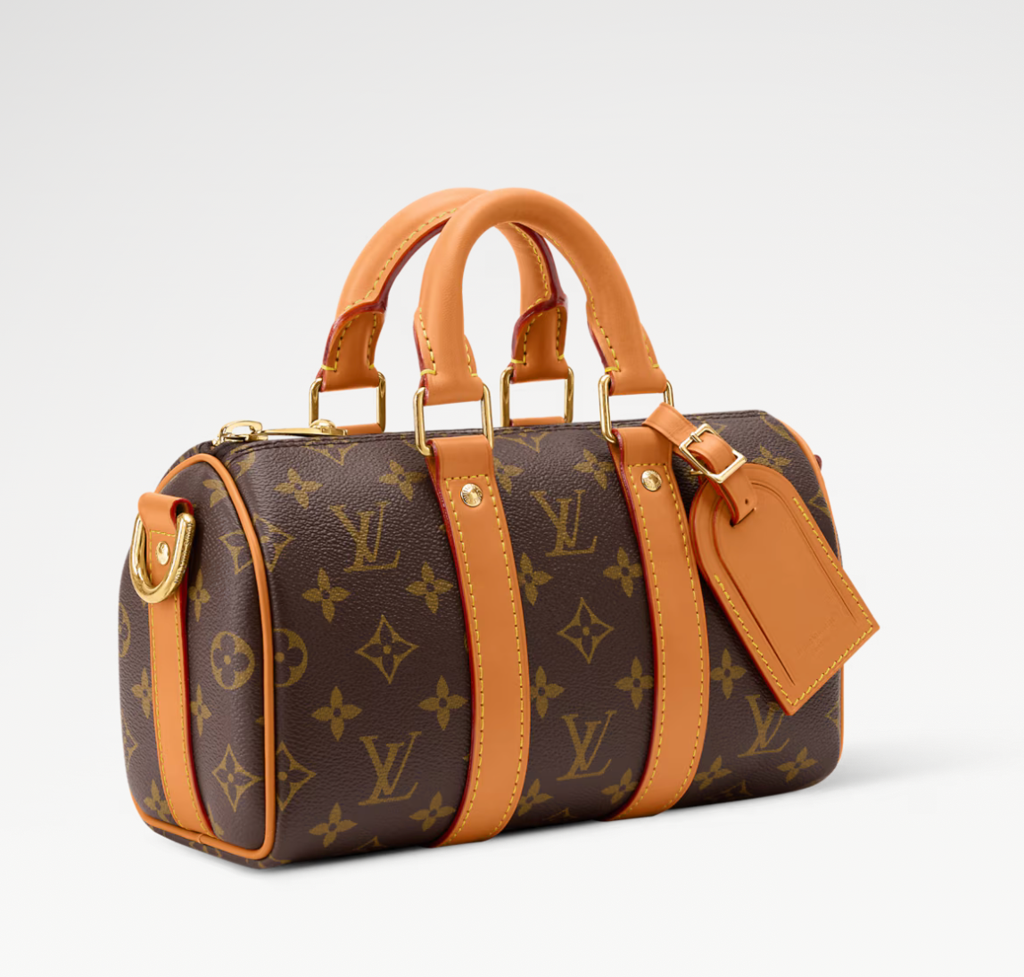Louis Vuitton Keepall Bandoulière 25 Monogram en toile Monogram avec garnitures en cuir naturel, poignées roulées, bandoulière réglable et amovible, fermeture zippée à double curseur et finitions métalliques.