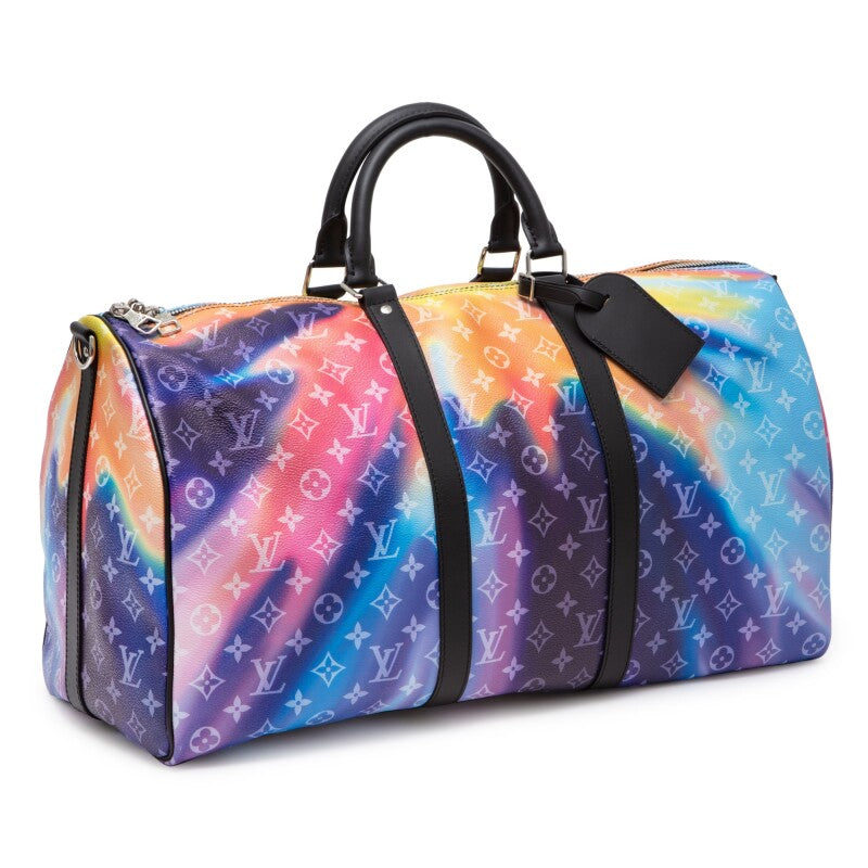 Louis Vuitton Keepall Bandoulière 50 Sunset Monogram Multicolor en toile Monogram multicolore avec garnitures en cuir naturel, poignées roulées, bandoulière amovible, fermeture zippée et finitions métalliques.