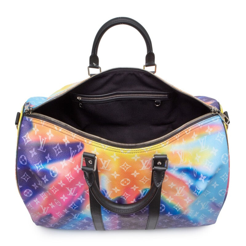 Louis Vuitton Keepall Bandoulière 50 Sunset Monogram Multicolor en toile Monogram multicolore avec garnitures en cuir naturel, poignées roulées, bandoulière amovible, fermeture zippée et finitions métalliques.