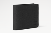 Louis Vuitton Slender Wallet Taiga Black en cuir Taïga noir texturé, format compact à deux volets avec silhouette fine.