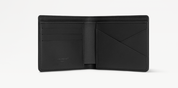 Louis Vuitton Slender Wallet Taiga Black en cuir Taïga noir texturé, format compact à deux volets avec silhouette fine.