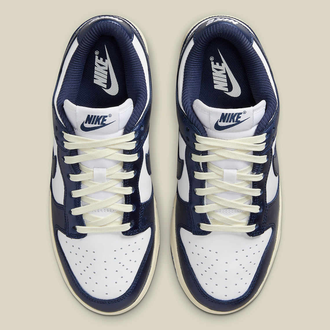 Nike Dunk Low PRM Vintage Navy, sneaker en cuir blanc et bleu marine avec Swoosh bleu et semelle crème effet vintage.