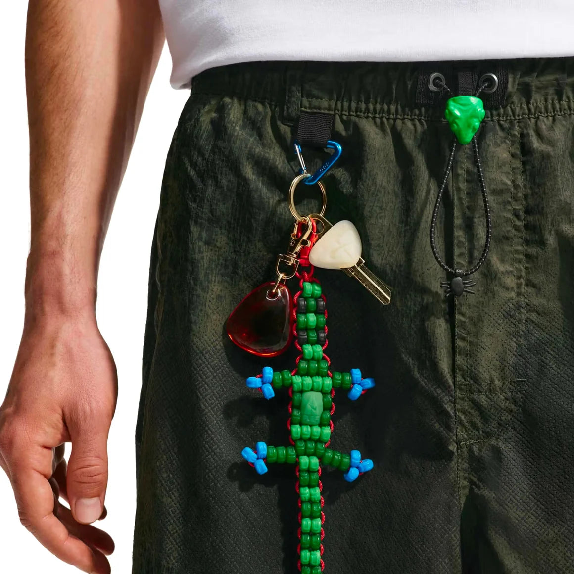 Nike ACG x CPFM Pant Multicolor, pantalon streetwear ample multicolore avec imprimé effet taches d’huile et détails techniques ACG.