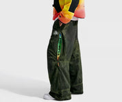 Nike ACG x CPFM Pant Multicolor, pantalon streetwear ample multicolore avec imprimé effet taches d’huile et détails techniques ACG.