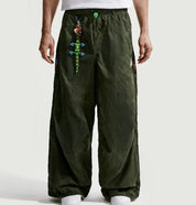 Nike ACG x CPFM Pant Multicolor, pantalon streetwear ample multicolore avec imprimé effet taches d’huile et détails techniques ACG.