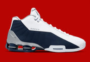 Nike Shox BB4 Olympics avec tige en cuir synthétique blanc et nubuck bleu marine, détails Metallic Silver, amorti Zoom Air à l'avant-pied et quatre colonnes Nike Shox au talon.