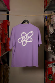 T-shirt Global Sneakers Unity Bloom en coton premium 230 g fabriqué au Portugal, avec logo brodé sur la poitrine et fleur GS en Puff Print au dos, disponible en Blanc, Rose, Vert et Lila.