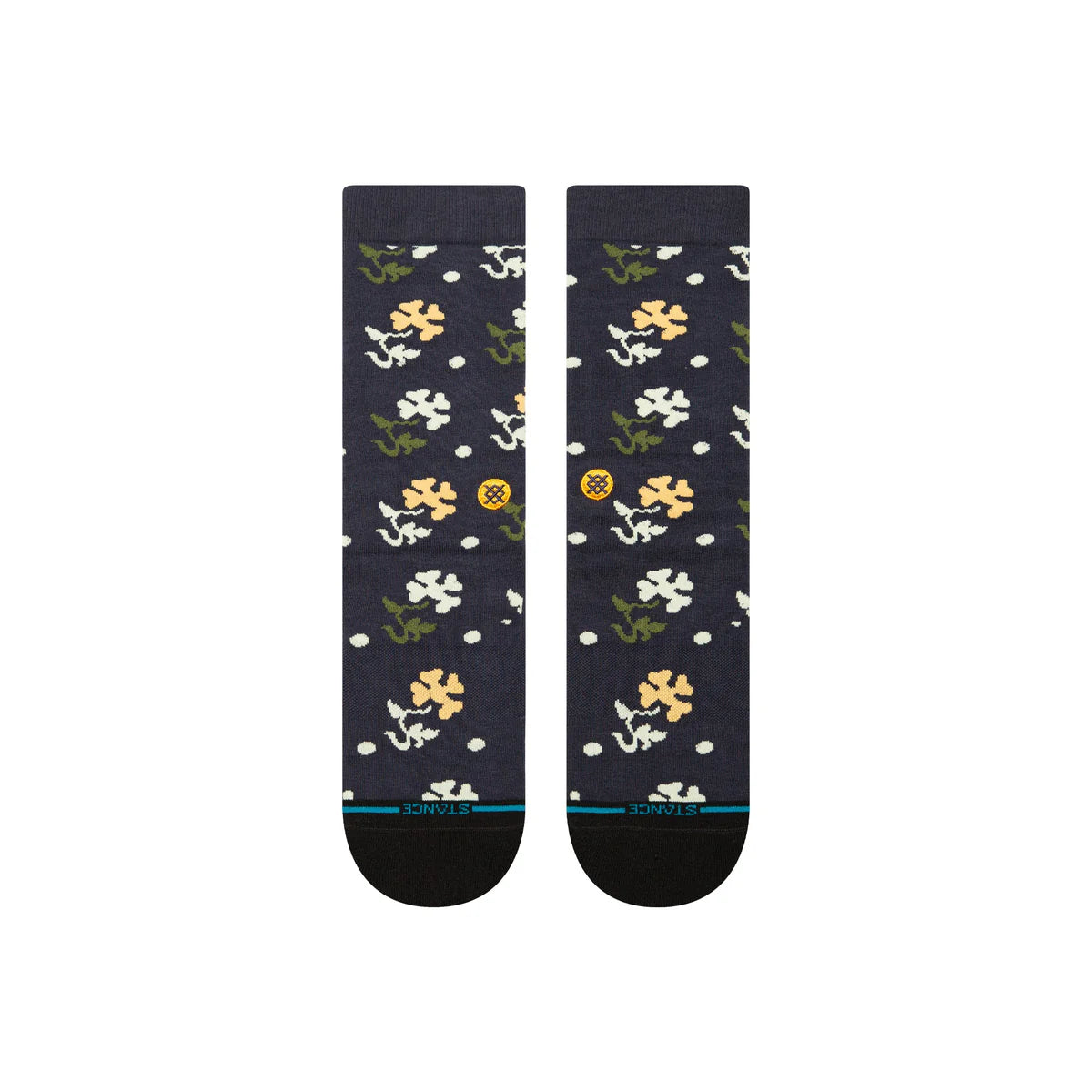 Paire de chaussette bleu marine à motif fleurs vert, blanc et jaune. La paire de chaussette est vue de dessus