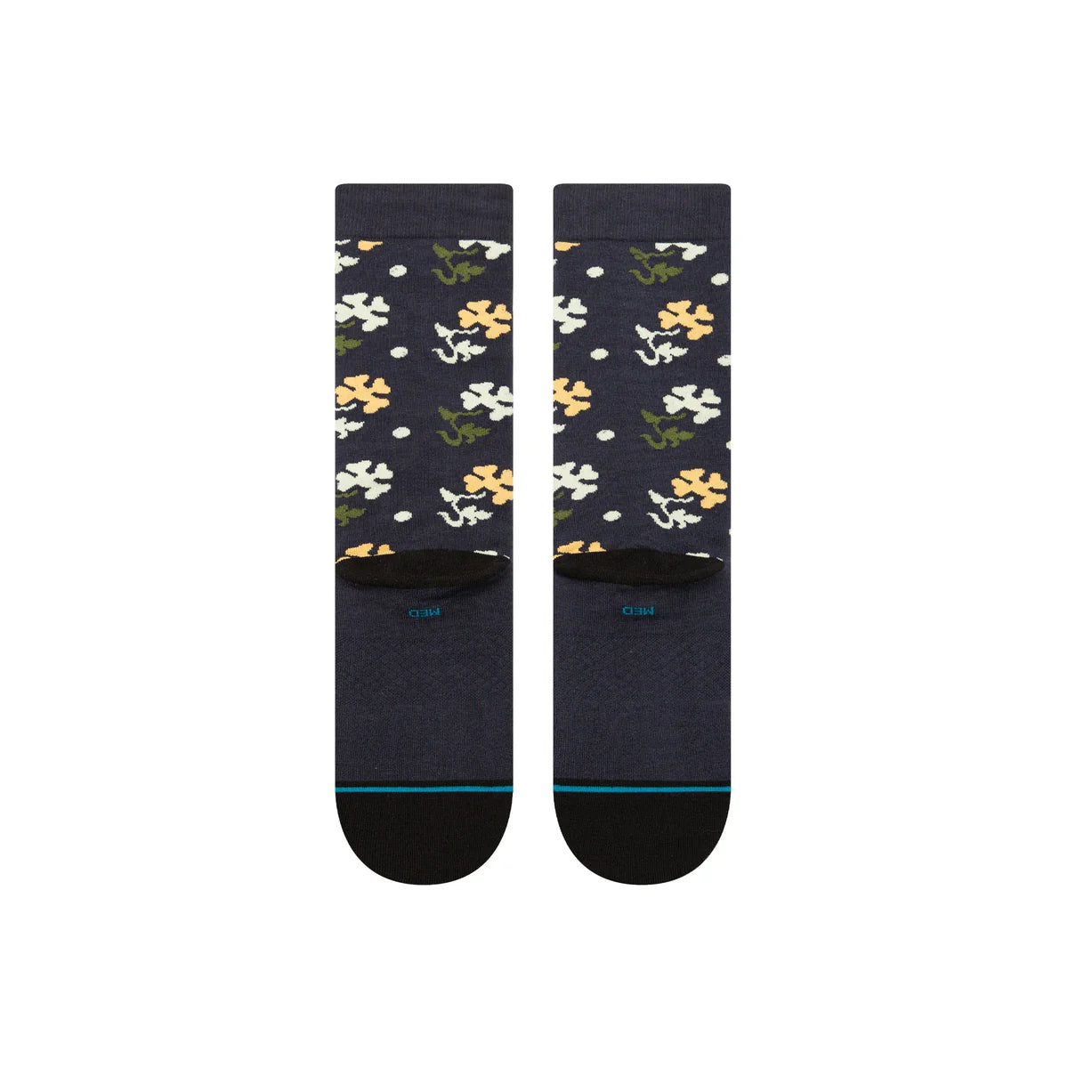 Paire de chaussette bleu marine à motif fleurs vert, blanc et jaune. La paire de chaussette est vue de derrière