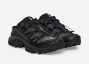 Salomon XT-4 Mule MM6 Maison Margiela Black Nine Iron en mesh noir et gris anthracite avec système Quicklace et construction ouverte au talon.