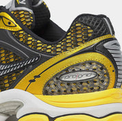 Saucony ProGrid Triumph 4 Lemon Chrome en mesh blanc avec superpositions jaune métallisé et amorti ProGrid.