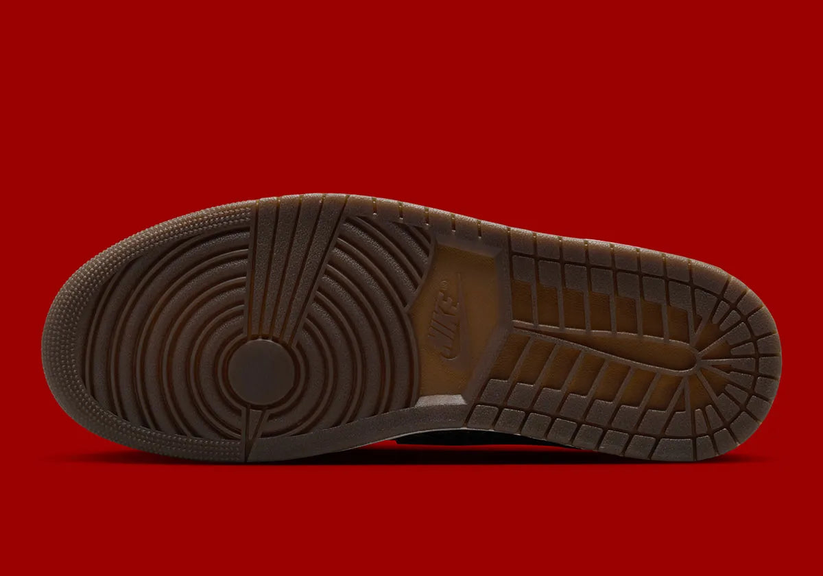 Air Jordan 1 Retro Low OG Laser Black University Red, sneaker noire en cuir gravé au laser avec détails marron, talon rouge et semelle blanche.