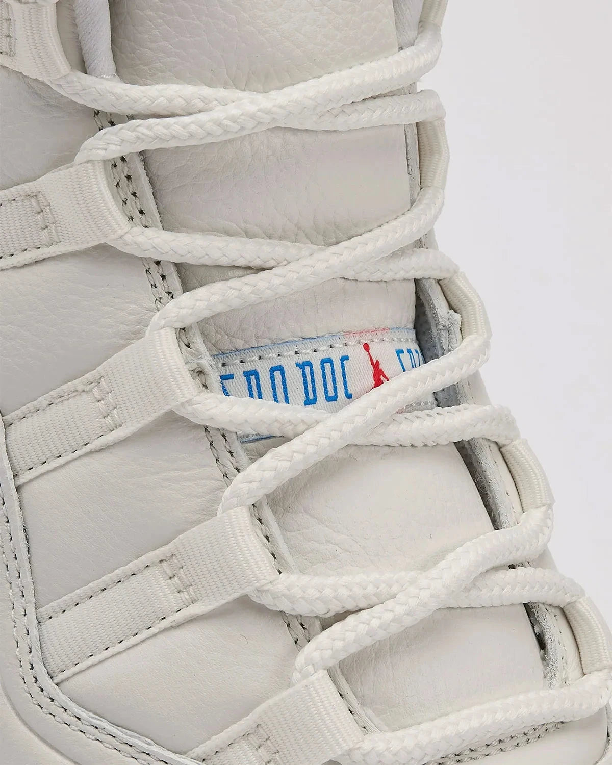 Détails sur la languette de la sneakers Air Jordan 11 Retro 285 en cuir verni et mesh technique avec semelle translucide et amorti Air iconique