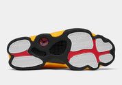 Air Jordan 13 Retro Del Sol 414571-167 en cuir blanc avec accents jaunes Del Sol, détails rouges, noirs et hologramme latéral vert vue de dessous. 