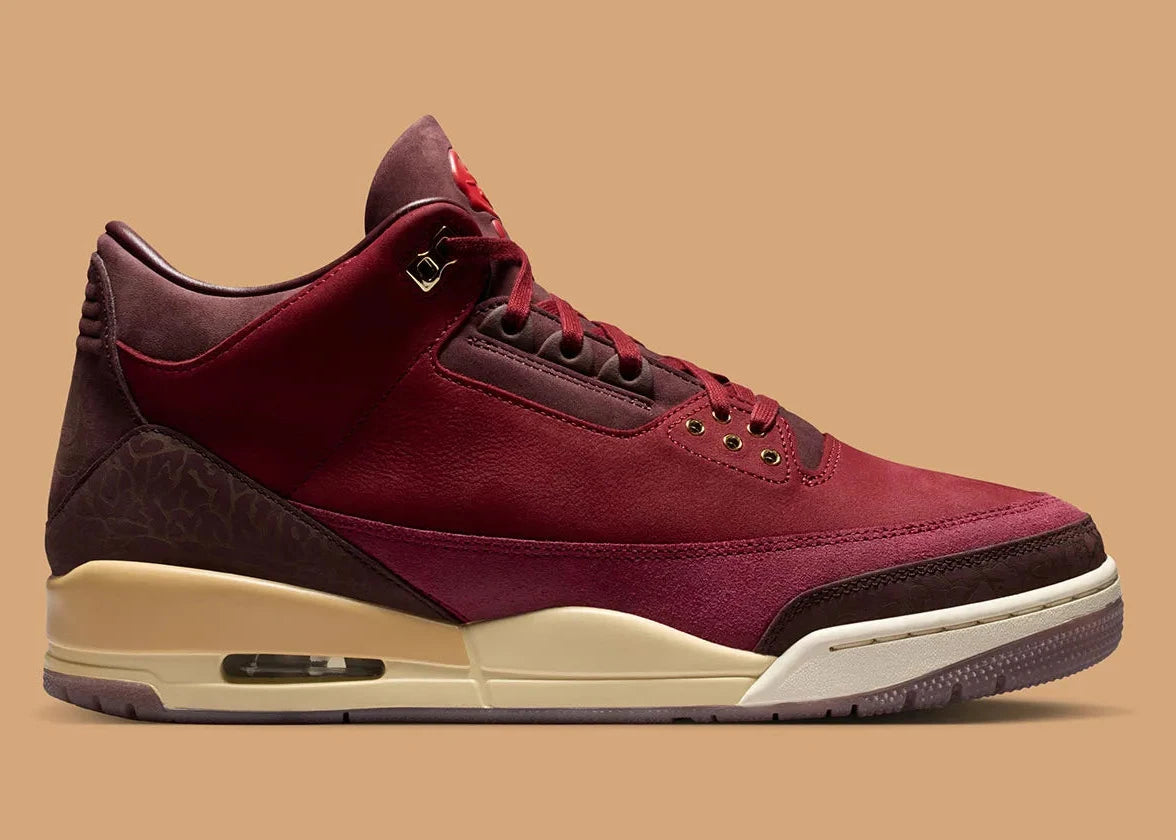 Air Jordan 3 Retro PRM Bin23 en cuir premium brun avec sceau rouge Bin23 et amorti Air visible emblématique.
