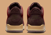 Air Jordan 3 Retro PRM Bin23 en cuir premium brun avec sceau rouge Bin23 et amorti Air visible emblématique.
