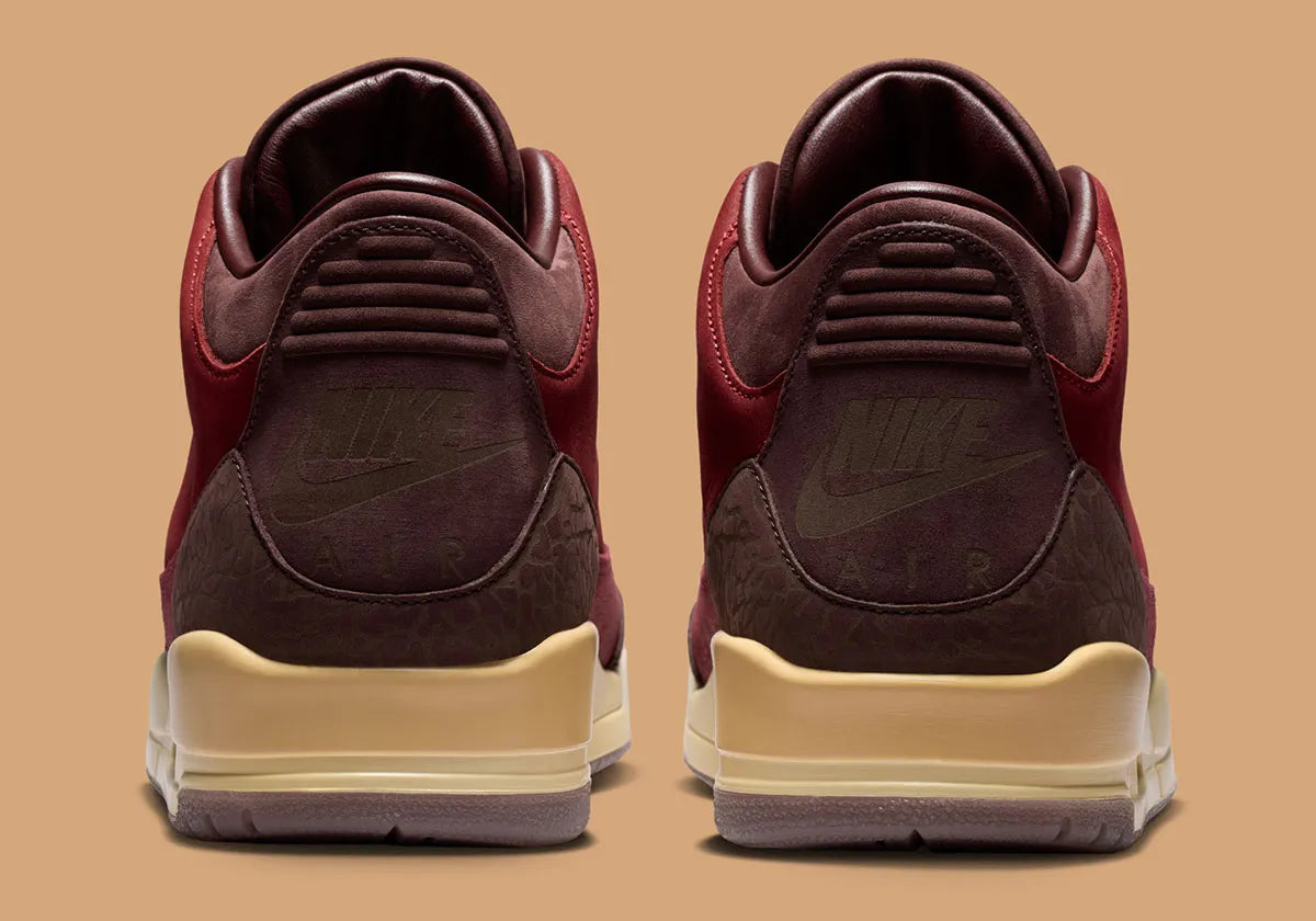 Air Jordan 3 Retro PRM Bin23 en cuir premium brun avec sceau rouge Bin23 et amorti Air visible emblématique.

