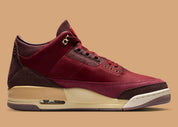 Air Jordan 3 Retro PRM Bin23 en cuir premium brun avec sceau rouge Bin23 et amorti Air visible emblématique.
