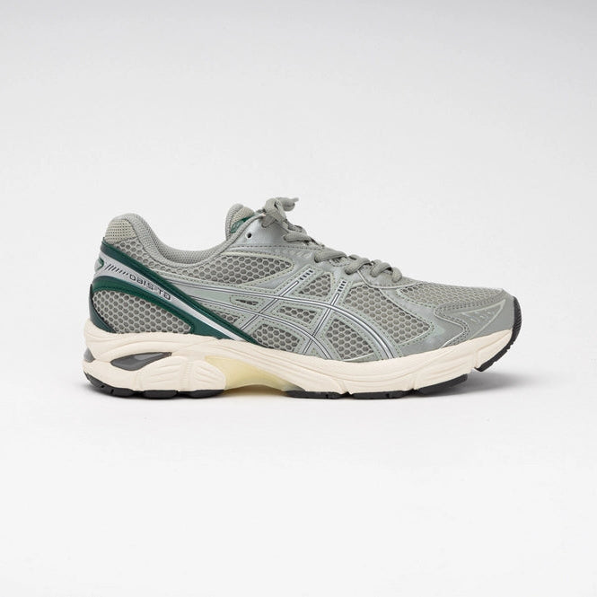 Sneaker ASICS GT-2160 Seal Grey Jewel Green en mesh gris avec détails verts et amorti GEL pour un confort optimal.