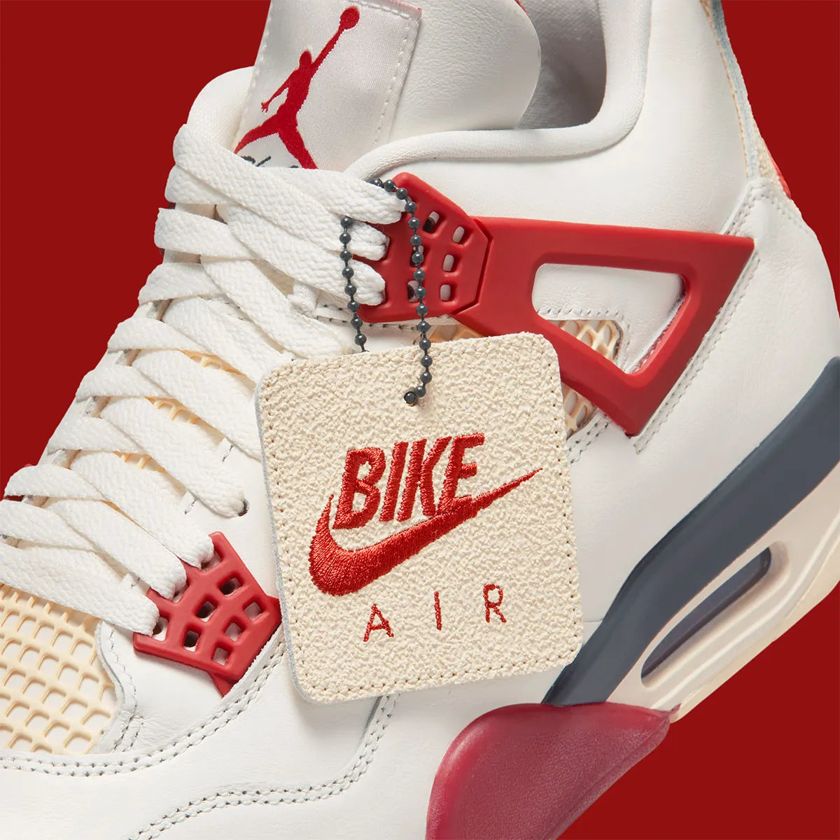 Sneaker Air Jordan 4 Nigel Sylvester Brick By Brick rouge brique en suède premium avec semelle Air visible et détails OG iconiques.