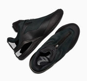 Converse SHAI 001 Charm Black, sneaker de basketball noire monochrome avec empeigne moulée, fermeture zippée et silhouette futuriste.