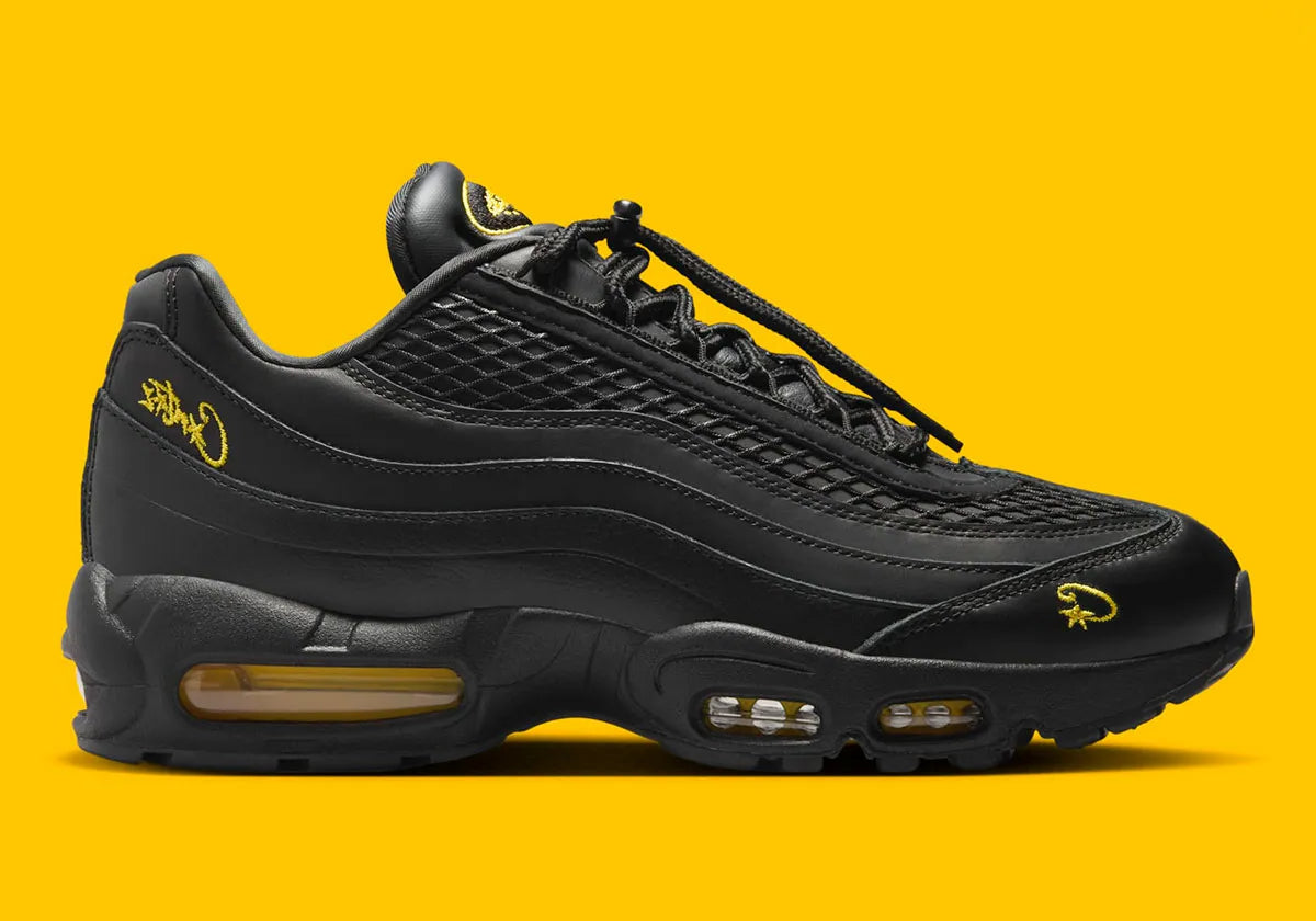 Nike Air Max 95 Corteiz Honey Black noire en cuir et mesh diamant avec détails Corteiz, logo Alcatraz et unités Air Max Tour Yellow vue de profil. 