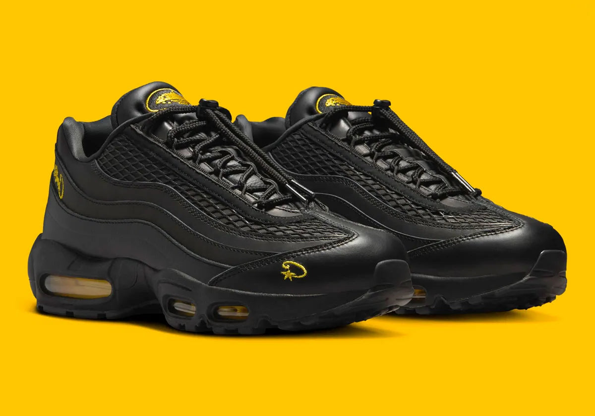 Nike Air Max 95 Corteiz Honey Black noire en cuir et mesh diamant avec détails Corteiz, logo Alcatraz et unités Air Max Tour Yellow vue de 3/4 face. 