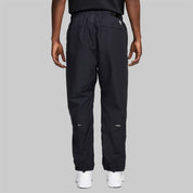 Nike x NOCTA Drake Northstar Nylon Track Pants Anthracite Grey, pantalon de survêtement en nylon gris anthracite avec poches zippées et logos NOCTA.