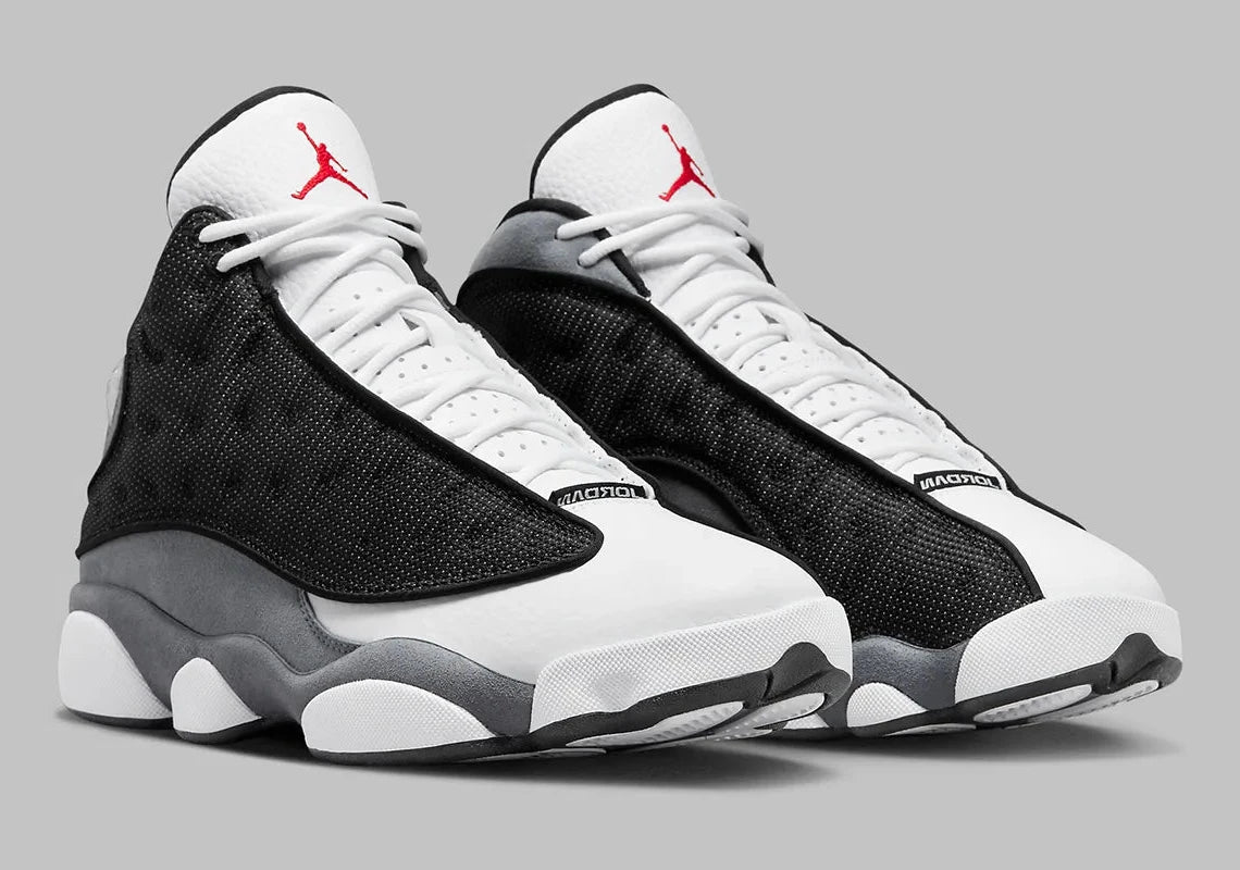 Air Jordan 13 Retro Black Flint DJ5982-060 en cuir blanc, suède Flint Grey et mesh noir réfléchissant avec Jumpman rouge vue de 3/4 face. 