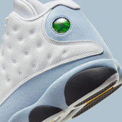 Vue zoomée sur les détails arrières de la Air Jordan 13 Retro Blue Grey 414571-170 en cuir blanc avec panneaux Blue Grey, détails noirs, accents Yellow Ochre et hologramme vert.