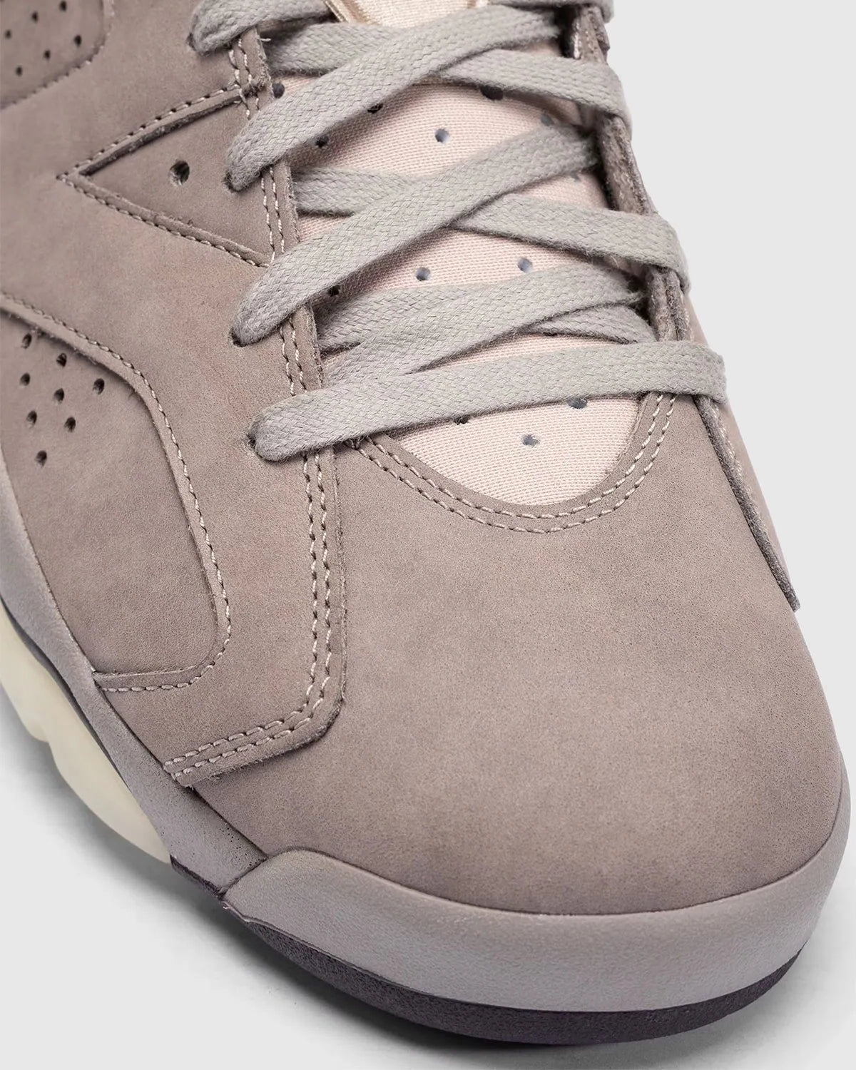 Air Jordan 6 A Ma Manière en suede Smokey Mauve avec accents crème et amorti Air visible vue zoomée sur les détails avant de la paire. 