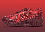 Sneaker New Balance 1906R en mesh gris mercure, cuir synthétique argent, accents rouge crimson, amorti ABZORB et N-ergy, silhouette rétro running premium