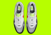 Nike Air Max 1 Chili Volt, sneaker Nike Air Max 1 avec coloris Chili et Volt, amorti Nike Air visible et finitions premium.